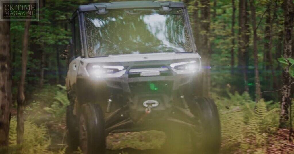 Off-road utility vehicle navigating forest trail in dense woods for outdoor adventure.
